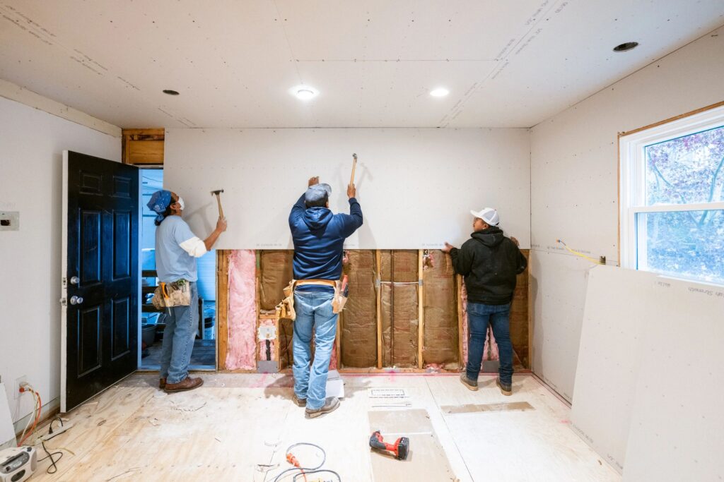 Drywall installers working in kitchen renovation